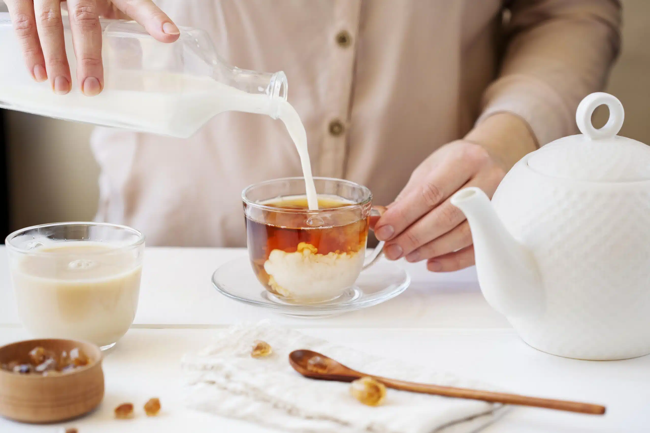 Does Thai Tea Have Caffeine? Everything About Cha Yen 1 front view person preparing milk tea scaled